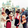 Prince Rainier and family at Sleeping Beauty Castle with Mickey Mouse, undated