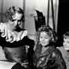 Shirley Temple and Marilyn Granas with teacher between scenes of Bright Eyes, 1934
